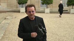 VOICED : Bono lider de U2 habla sobre pobreza con presidente frances News Clip
