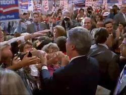 1992 high angle medium shot tracking shot Bill Clinton shaking hands, hugging, and kissing members of convention crowd Stock Footage
