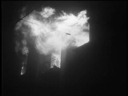 B/W 1939 low angle building burning at night after German bombing / Warsaw, Poland / documentary Stock Footage