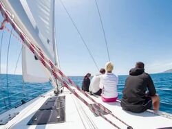 WS People Sitting On Deck Of Sailboat Stock Footage