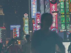 MS SLO MO Shot of Neon street signs in city downtown, with people walking by in foreground / Shanghai, China  Stock Footage