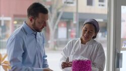 Restaurant owner checks in on pastry chef working on gourmet cake Stock Footage