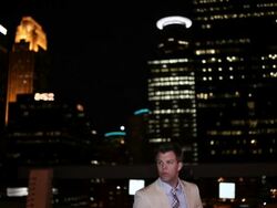 MS TD Well dressed young man standing next to his modern convertible car with confidence at night in urban area / Minneapolis, Minnesota, United States Stock Footage