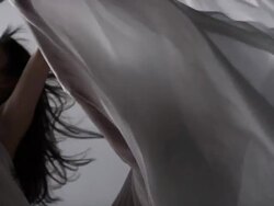 portrait of three woman draped with white silk fabric that moves with them Stock Footage