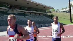 Male runners on track Stock Footage