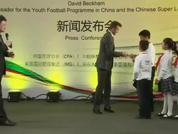 David Beckham on stage with school children News Clip