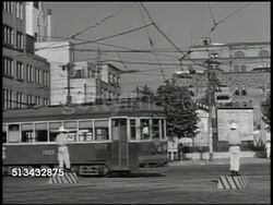 1945: OCCUPIED JAPAN: MILITARY POLICE: VS United States Military Police (MP) directing traffic on street w/ Japanese officer, trolley passing by, officers talking before driving off in Jeep. Post World War II Instructional Video