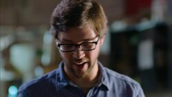 Woodworker studies tablet computer as excited shop owner shows off contoured design on new skateboard Stock Footage