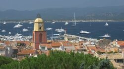St Tropez with Church Bell Tower and yachts passing.4K Stock Footage