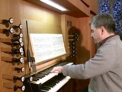 MS TU Organist looking in music book and playing organ  / Saarburg, Rhineland-Palatinate, Germany Stock Footage