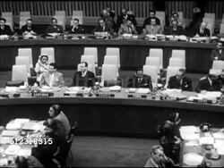 1952: NEW YORK, NEW YORK: UNITED NATIONS: U.N. Secretariat building w/ East River FG, WS U.N. Headquarters building roof, TD WS Member flags flying on flagpoles. VS Assembly, unidentified Middle East member speaking, empty France chair. Instructional Video