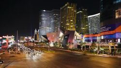 Traffic moves through an intersection along Las Vegas Boulevard past casinos in Las Vegas, Nevada. Stock Footage
