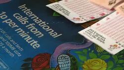 Newsagent selling lottery tickets in shop News Clip