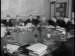 1941: AUSTRALIAN WAR COUNCIL: Advisory War Council seated at round table (PM Menzies seated center). MS Three members. MS three members. Rt Hon Sir Robert Menzies sitting (C) w/ John Curtain (L). WWII Instructional Video