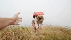 Man offering a helping hand to hiker female Stock Footage