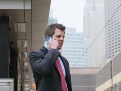 MS Well dressed young man using cellular device in downtown urban area next to commuter train / Minneapolis, Minnesota, United States Stock Footage