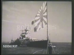 1942: JAPAN: WARSHIP LAUNCHING: MS Two rows of Imperial Japanese Navy,  IJN, soldiers standing w/ rifles on deck of warship. WS Japanese flag flying on ship, battleship at sea BG. MS Battleship moving. MS Officer & seamen steering smaller ship. WWII Instructional Video