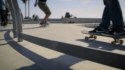 moving dolly shot of skaters doing tricks venice california Stock Footage