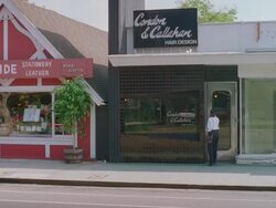 WS View of Cordon & Callahan modern black tile hair salon and woman enters / Brentwood California, United States Stock Footage