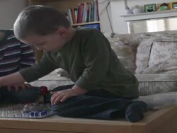 Two boys play game together on table in living room  Stock Footage