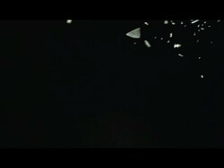 Shards of ice or glass falling against black background Stock Footage