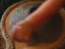 CU Shot of woman turning wheel to grind almonds into argon oil / casablanca, centro, morocco Stock Footage