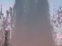 MS SLO MO TD Shot of water fountain at sunset with pink hue / Copenhagen, Denmark Stock Footage