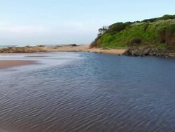WS PAN Shot of Lagoon or estuary surrounded by lush vegetation and esturary mouth and ocean  / Aliwal Shoal, Kwa Zulu Natal, South Africa Stock Footage