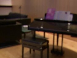 Medium Close Up pan-right - A glass of red wine awaits visitors to a piano showroom.   Stock Footage