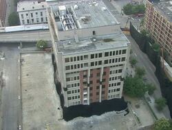 WS Building in the middle of the city is demolished in controlled implosion using explosives creating huge dust cloud / Louisvile, Kentucky, USA Stock Footage