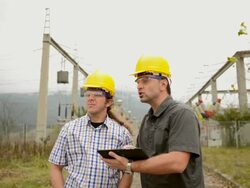 Engineers in front power station using tablet Stock Footage