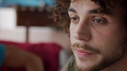 Guys sitting on couch watching tv Stock Footage