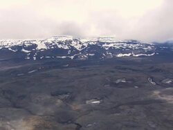 WS AERIAL View of snowy mountain at Cinder cone on lava plain / Iceland Stock Footage
