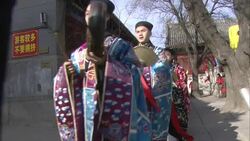 Men in traditional clothing parade musical instruments at a festival in Beijing, China. Stock Footage