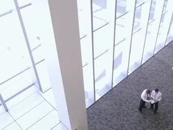  HA Businessmen meeting in lobby area, discussing documents, then leaving in opposite directions / Seattle, Washington, United States Stock Footage