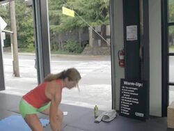 Camera tracks around Jean Anne as she performs series of dumbell snatches. Stock Footage