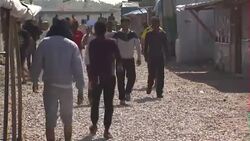 Migrants walking in Calais Jungle camp News Clip