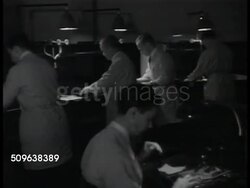 1941: MODERN LAB TECHNIQUES: FBI Technicians soaking papers, wanted posters, photographs in solution. Printing multiple photo & fingerprint pages of man in uniform. Instructional Video