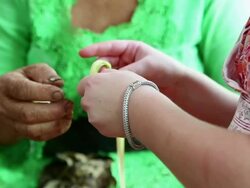CU Shot of woman and child working with blade of grass / Ubud, Bali, Indonesia Stock Footage