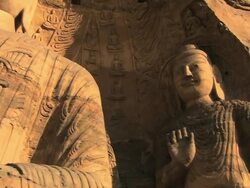 MS PAN TU Shot of big Buddha sutra carving and smaller figure next to it at Yungang Grottoes / Datong, Shanxi Province, China Stock Footage