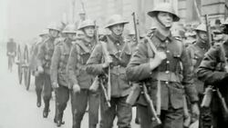 1921 WS British Army soldiers marching on the street, followed by horse-drawn wagons and bicycle messenger, during the Great Coal Crisis of 1921 / United Kingdom Stock Footage