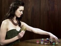 Young woman winning card game, throwing card in the air Stock Footage
