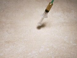 MS SLO MO Syringe with liquid falling floor / Vieux Pont, Normandy, France  Stock Footage