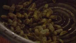 Silk cocoon husks drop in to a kettle. Stock Footage