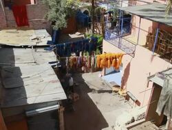 MS Shot of several handwoven rugs hanging out to dry in line outside / marrakech, tensift, morocco Stock Footage