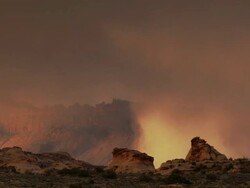 Storm clouds in distant desert canyon - medium Stock Footage