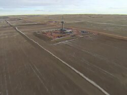 WS AERIAL Shot of two oil drilling rigs in Bakken oil field near Watford City / Watford City, North Dakota, United States Stock Footage