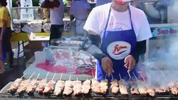 Cooking Chicken Skewers in a FV Food Stand during the Taste of Manila Festival-Toronto,Canada Stock Footage