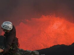 Climber watches volcano erupt large amounts of lava, Marum Volcano, Ambrym Island, Vanuatu Stock Footage
