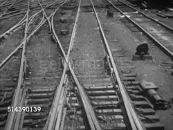1953: OMAHA, NEBRASKA:  PAN (R) From MS train passing by over bridge to WS Omaha city in Nebraska & the Missouri River. VS Passenger train pulling into Union Station (aka Union Passenger Terminal, not Burlington Station). NE, Omaha Landmark Instructional Video